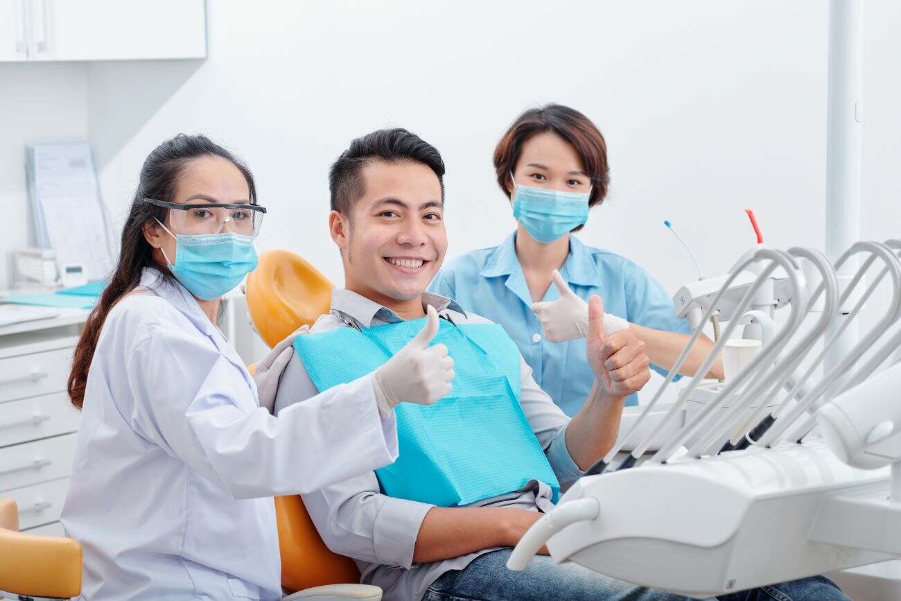 happy patient and dentists Dentistry on Danforth